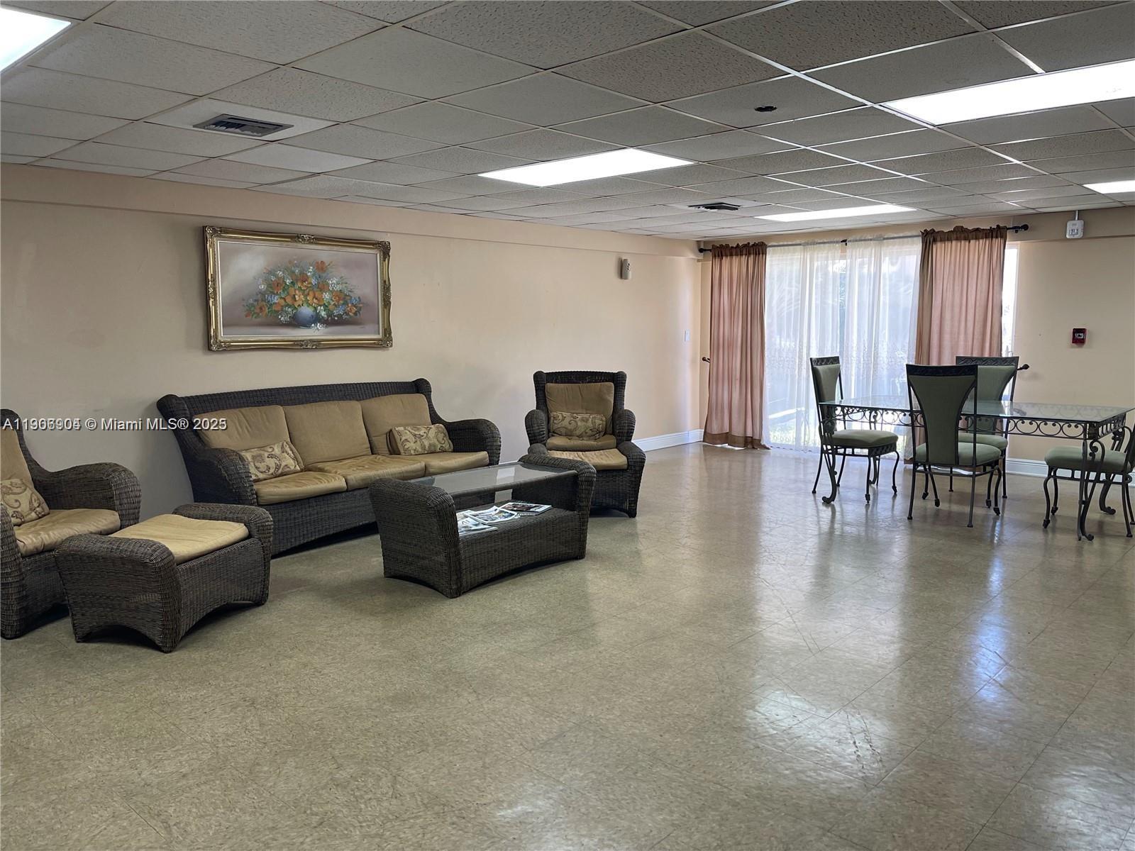 4670 West 13th Lane, Unit 504 Hialeah, FL 33012 - Photo 16 of 16 a living room with furniture and wooden floor