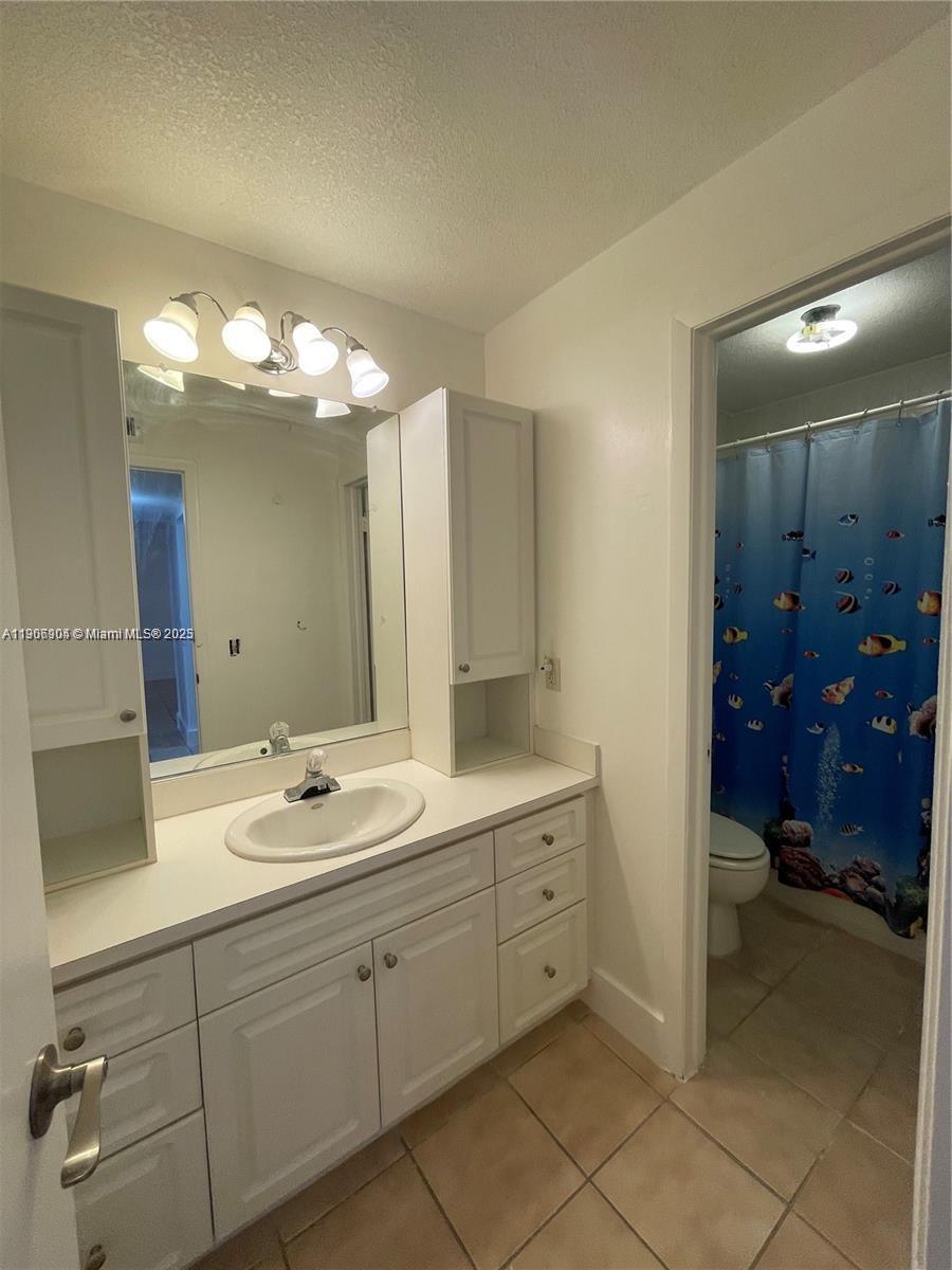 4670 West 13th Lane, Unit 504 Hialeah, FL 33012 - Photo 5 of 16 a spacious bathroom with a double vanity sink mirror and shower