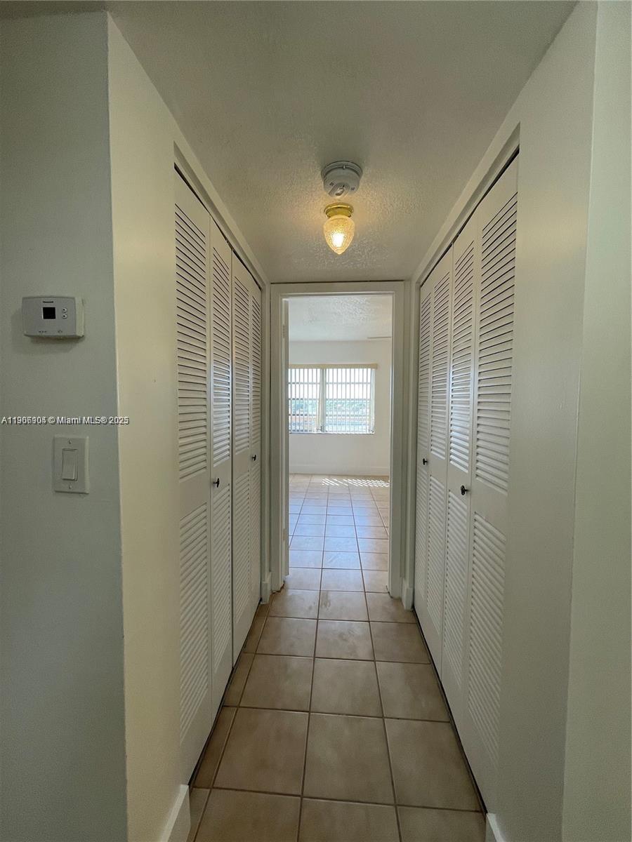 4670 West 13th Lane, Unit 504 Hialeah, FL 33012 - Photo 6 of 16 a view of hallway with windows