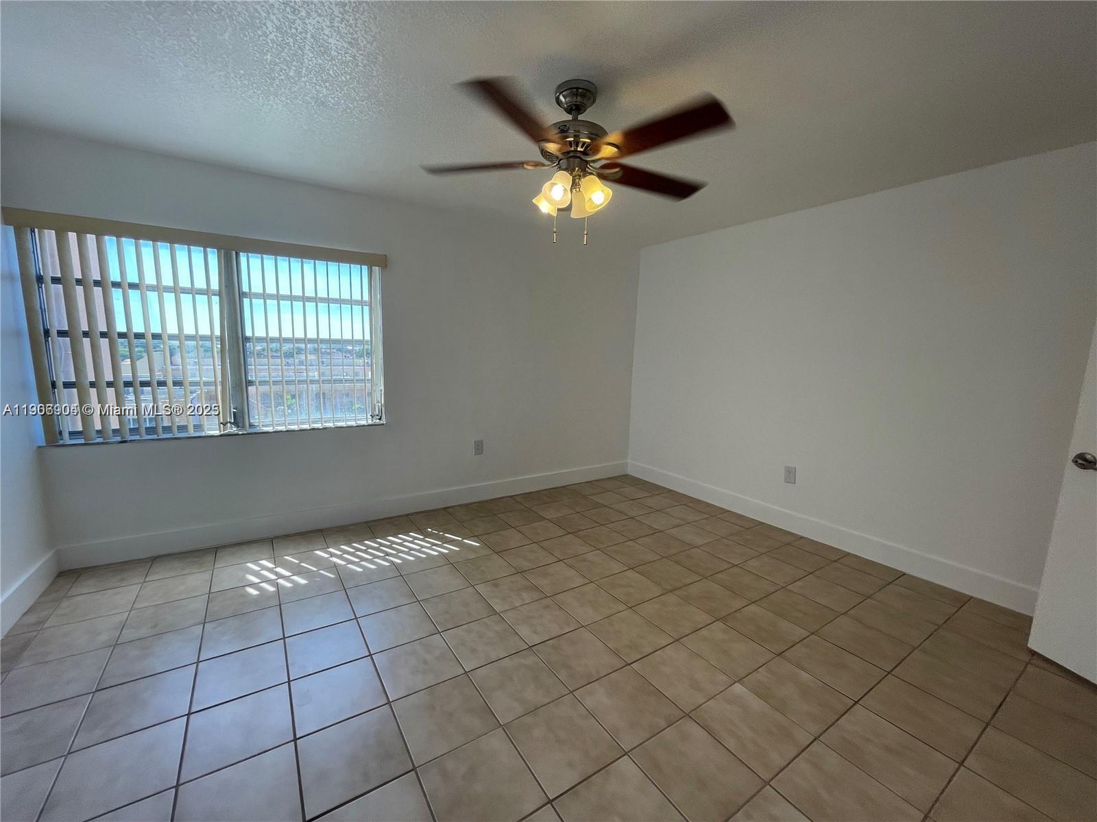 4670 West 13th Lane, Unit 504 Hialeah, FL 33012 - Photo 8 of 16 a view of an empty room and window
