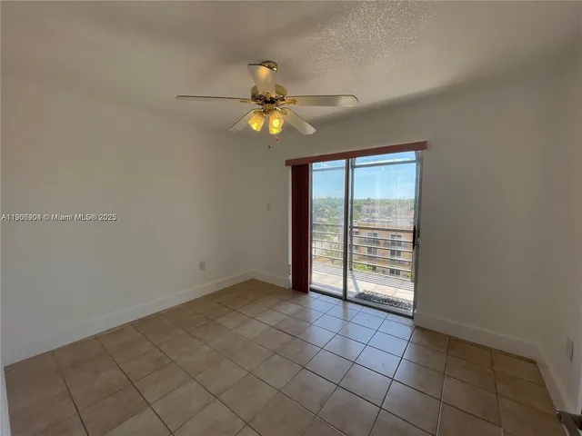 a kitchen with granite countertop a refrigerator and a stove top oven