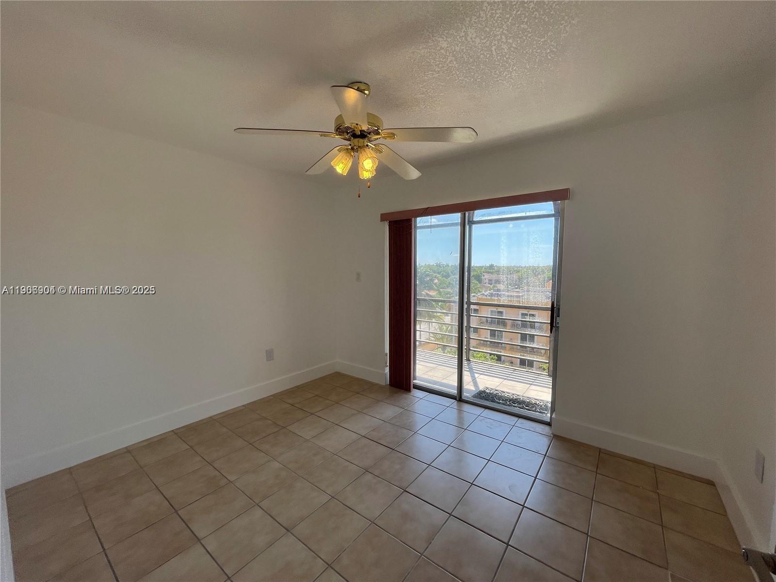 4670 West 13th Lane, Unit 504 Hialeah, FL 33012 - Photo 10 of 16 a view of an empty room with a window