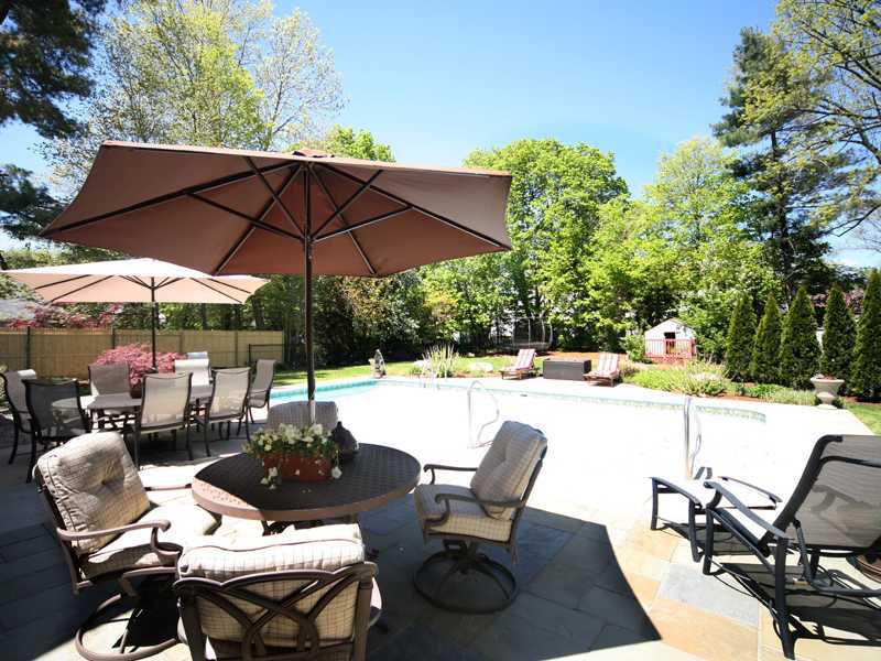 27 Middlesex Road Darien, CT 06820 - Photo 18 of 20 a view of an outdoor sitting area with furniture and umbrella