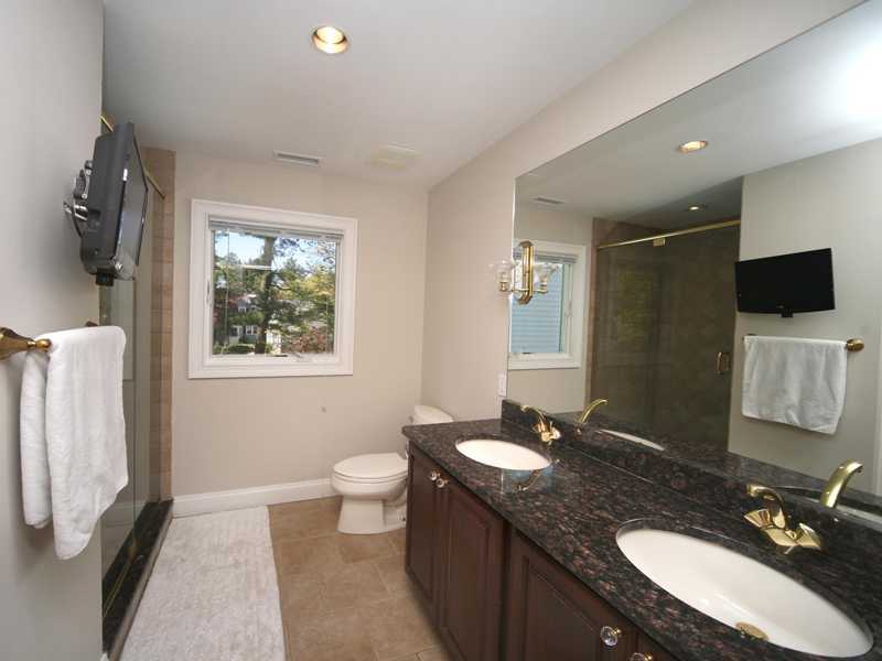 27 Middlesex Road Darien, CT 06820 - Photo 9 of 20 a bathroom with a granite countertop sink toilet and mirror