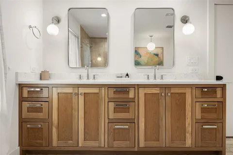 a bathroom with a double vanity sink and a mirror