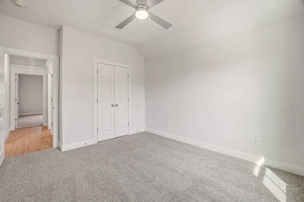 2017 Forest Bridge Azle, TX 76020 - Photo 24 of 30 Unfurnished bedroom featuring light carpet, vaulted ceiling, ceiling fan, and a closet