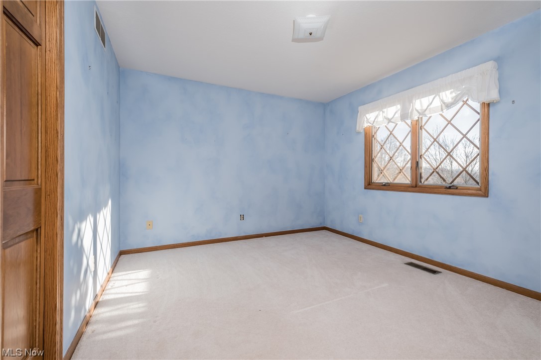 6216 Rockside Circle Northwest Canton, OH 44718 - Photo 24 of 33 Secondary Bedroom with light colored carpet and Blue walls