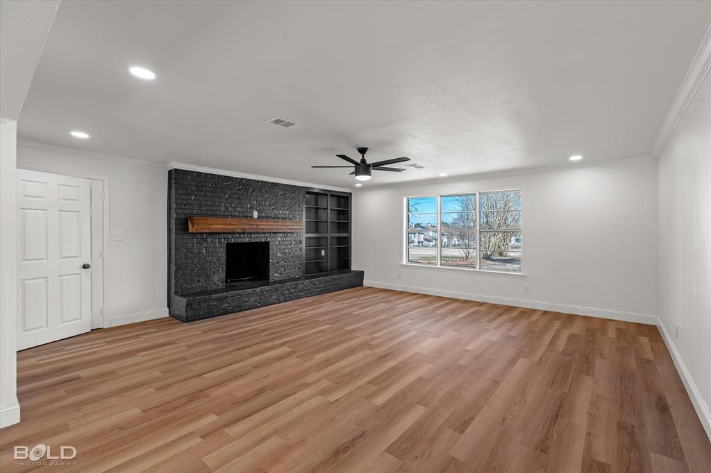 4136 Pines Road Shreveport, LA 71119 - Photo 14 of 38 Unfurnished living room featuring light wood finished floors, a fireplace, crown molding, recessed lighting, and a ceiling fan