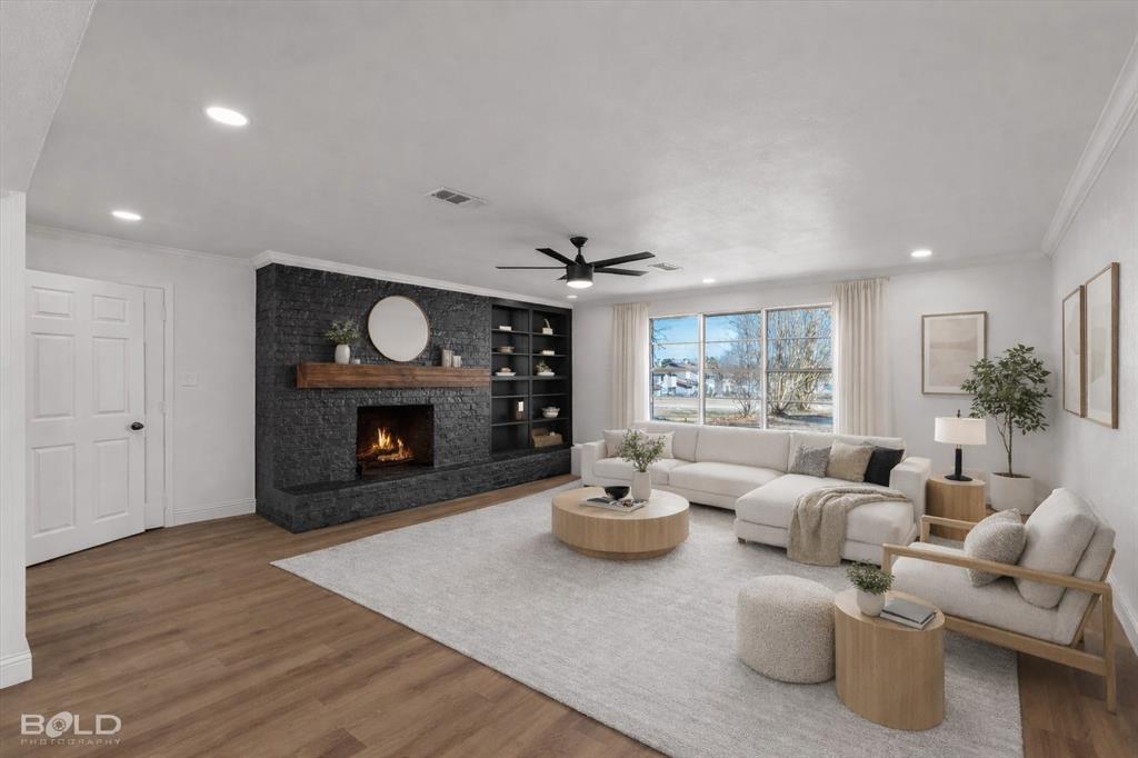 4136 Pines Road Shreveport, LA 71119 - Photo 15 of 38 Living room featuring ornamental molding, wood finished floors, a large fireplace, a ceiling fan, and recessed lighting