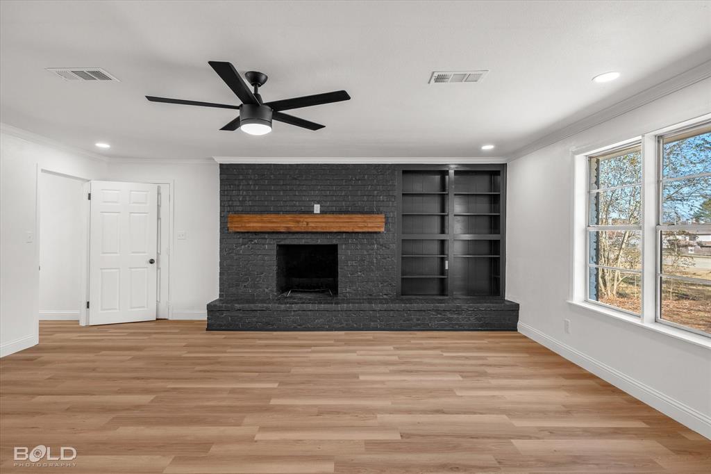 4136 Pines Road Shreveport, LA 71119 - Photo 16 of 38 Unfurnished living room with light wood-style floors, recessed lighting, a brick fireplace, ornamental molding, and ceiling fan