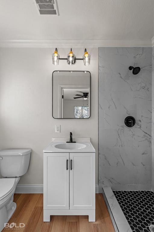 4136 Pines Road Shreveport, LA 71119 - Photo 22 of 38 Full bathroom with ornamental molding, vanity, a shower stall, light wood-style floors, and baseboard heating