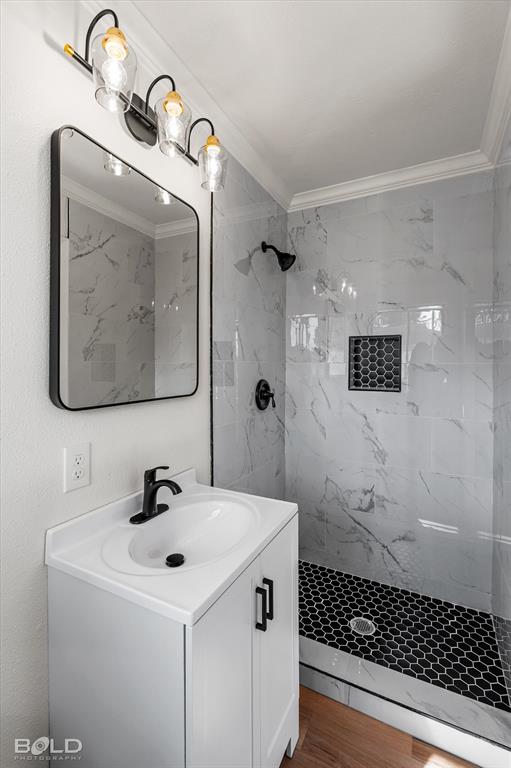 4136 Pines Road Shreveport, LA 71119 - Photo 23 of 38 Full bathroom with a marble finish shower, ornamental molding, vanity, and wood finished floors