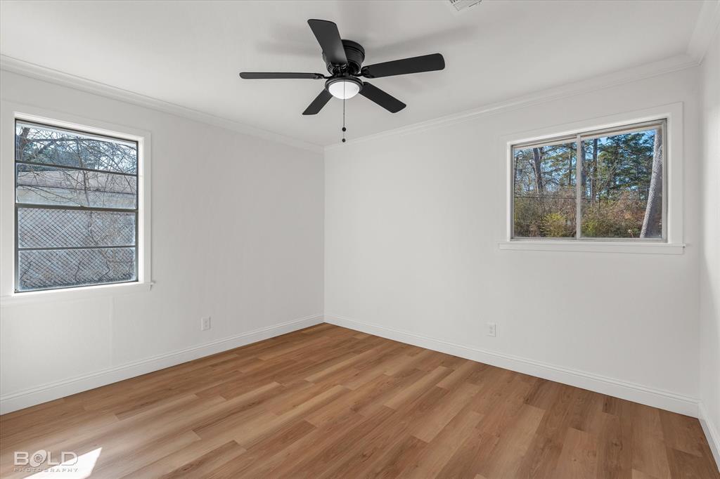 4136 Pines Road Shreveport, LA 71119 - Photo 24 of 38 Spare room with crown molding, light wood finished floors, and a ceiling fan