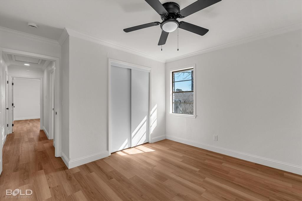 4136 Pines Road Shreveport, LA 71119 - Photo 25 of 38 Unfurnished bedroom featuring crown molding, light wood-style floors, a closet, and a ceiling fan