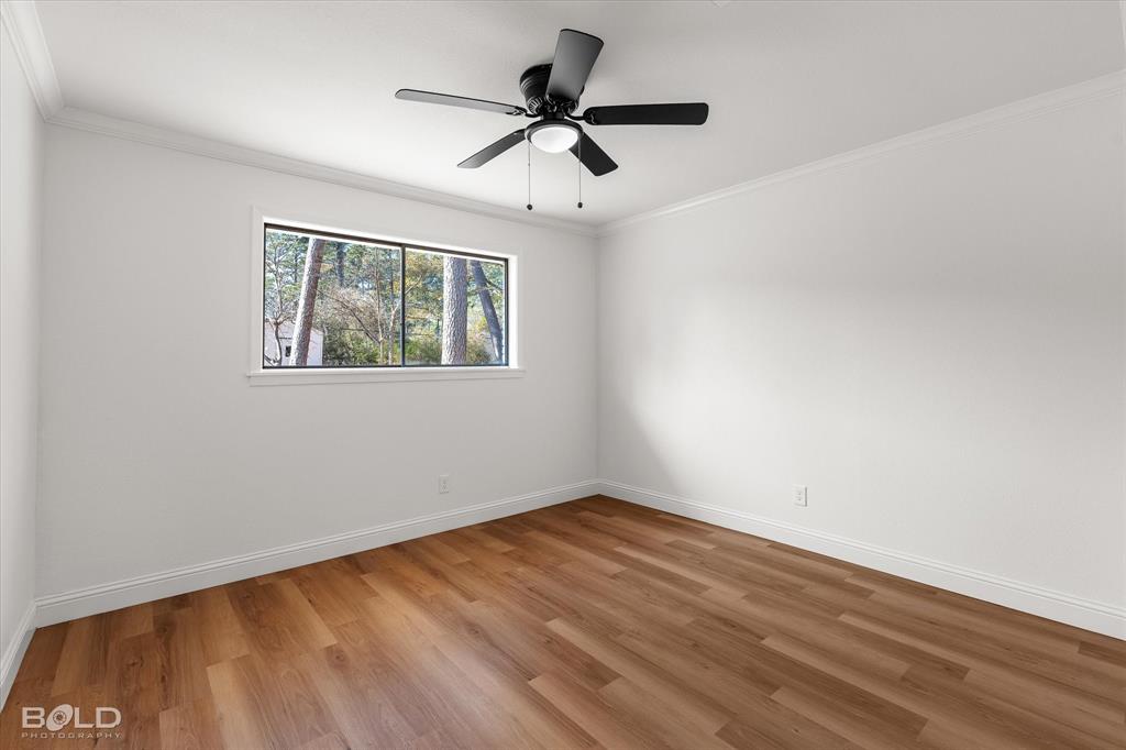 4136 Pines Road Shreveport, LA 71119 - Photo 26 of 38 Spare room featuring crown molding, light wood-style flooring, and a ceiling fan