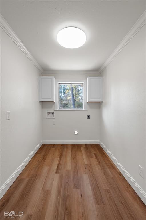 4136 Pines Road Shreveport, LA 71119 - Photo 28 of 38 Laundry area with cabinet space, light wood-style floors, washer hookup, crown molding, and electric dryer hookup