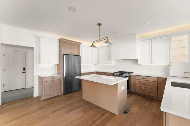 a kitchen with a stove a sink and a refrigerator