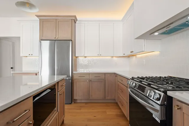 a kitchen with a refrigerator and a sink