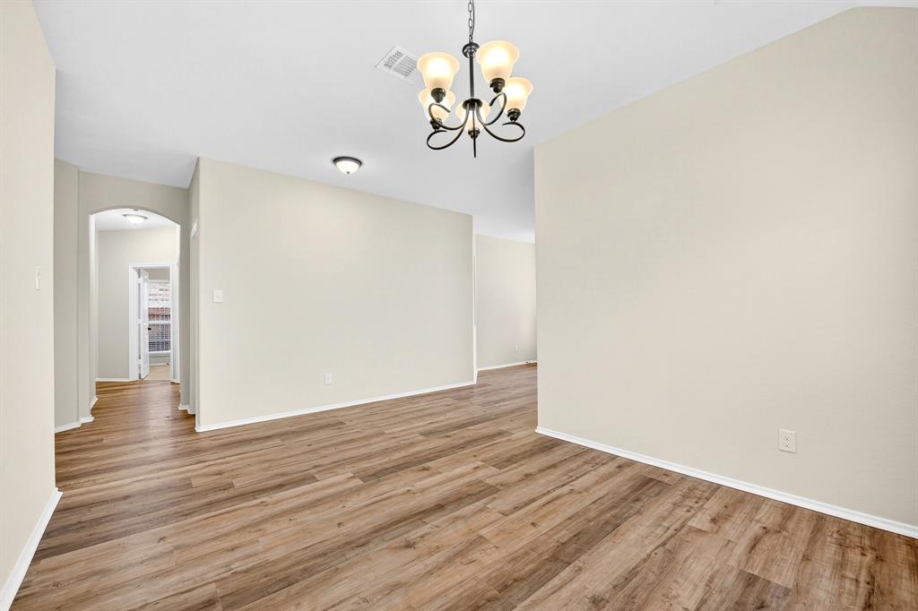 217 Rugby Lane McKinney, TX 75072 - Photo 12 of 40 a view of a hallway with wooden floor