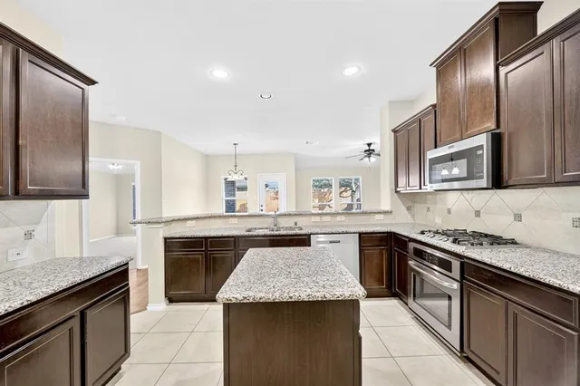 a kitchen with granite countertop stainless steel appliances and sink