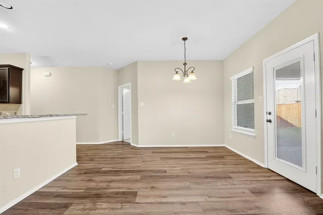 a view of a kitchen with a sink and dishwasher wooden floor