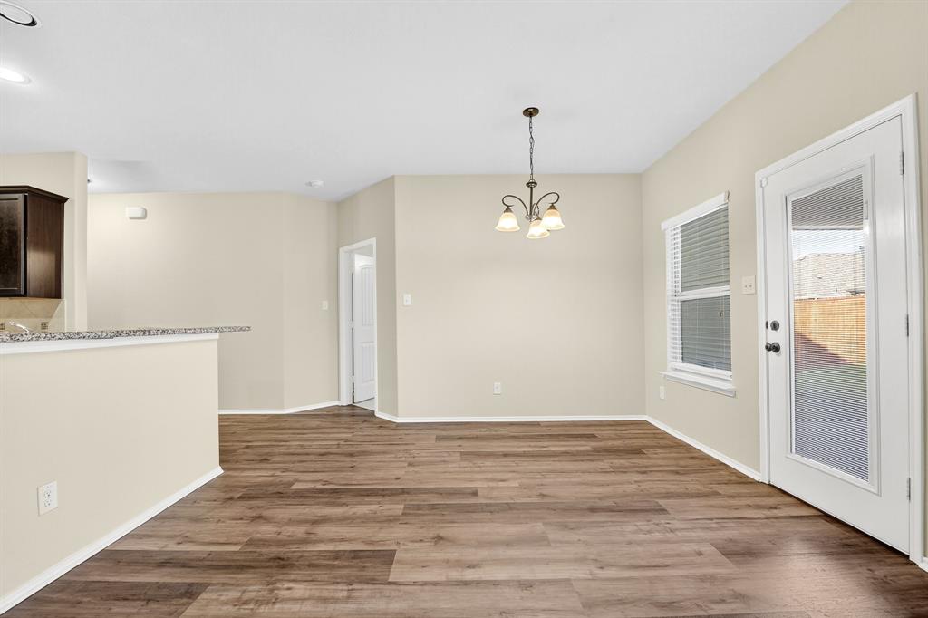 217 Rugby Lane McKinney, TX 75072 - Photo 21 of 40 a view of a kitchen with a sink and dishwasher wooden floor