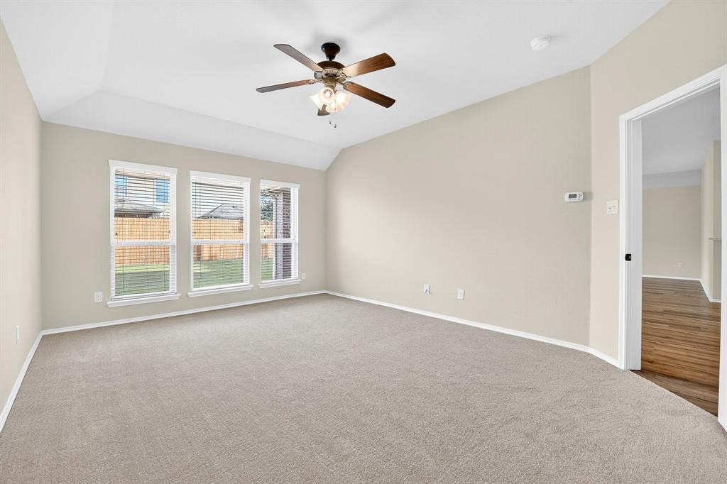 217 Rugby Lane McKinney, TX 75072 - Photo 28 of 40 an empty room with windows and ceiling fan
