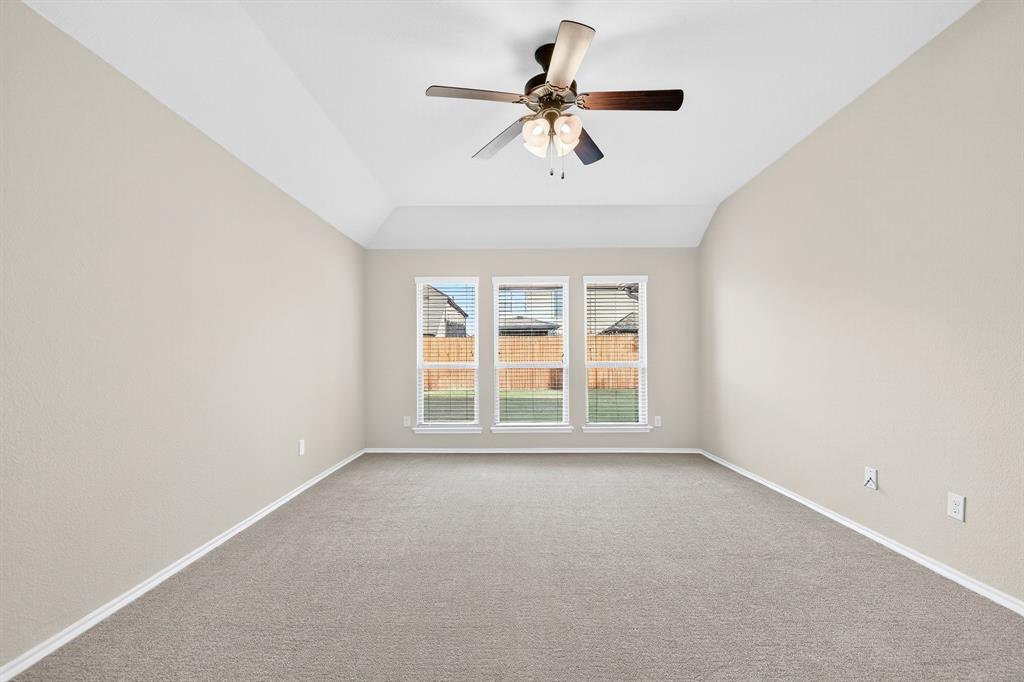 217 Rugby Lane McKinney, TX 75072 - Photo 29 of 40 an empty room with a window and a ceiling fan