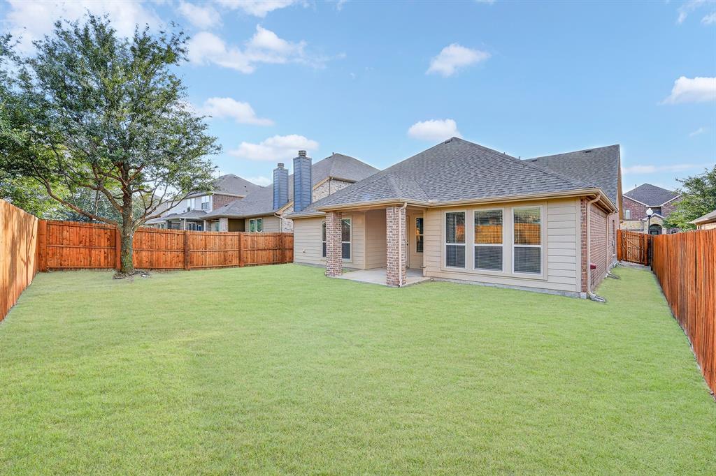 217 Rugby Lane McKinney, TX 75072 - Photo 39 of 40 a front view of a house with a garden