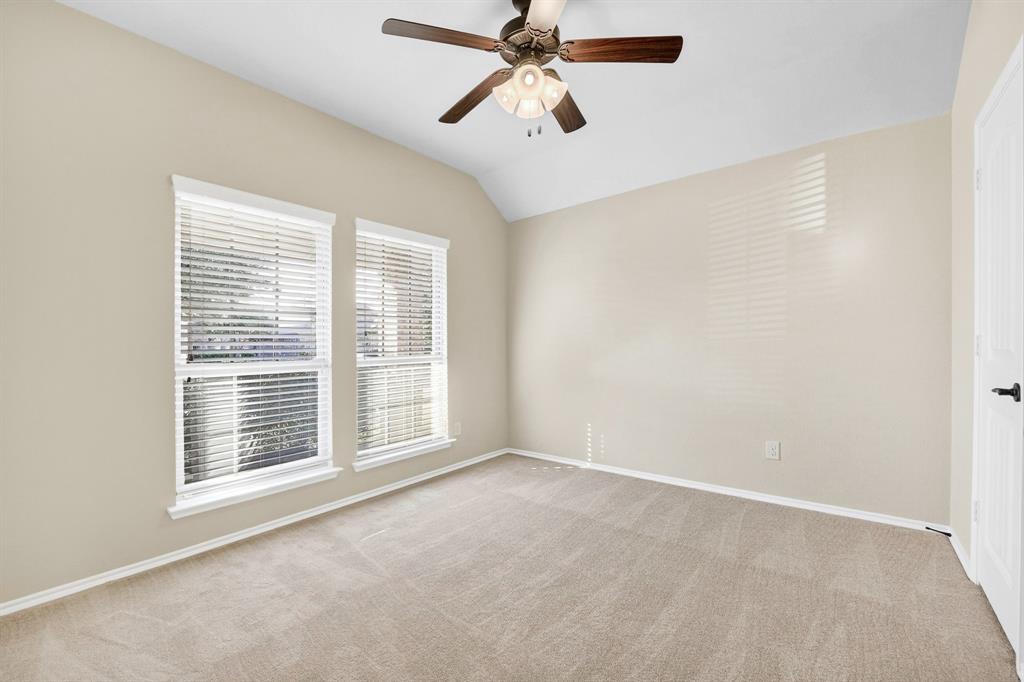 217 Rugby Lane McKinney, TX 75072 - Photo 7 of 40 a view of an empty room with chandelier fan and a window