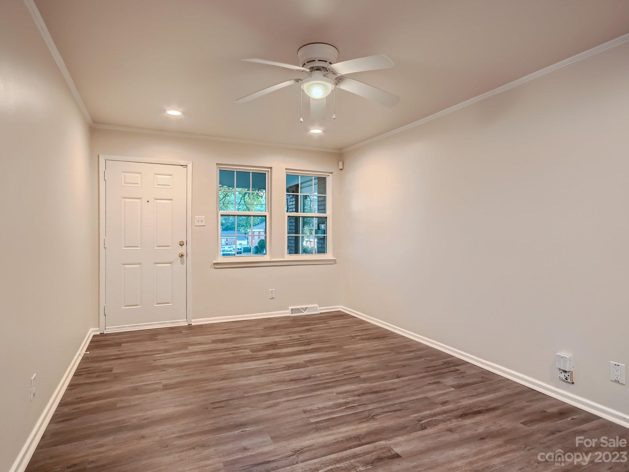 3219 Minnesota Road Charlotte, NC 28208 - Photo 2 of 11 wooden floor in an empty room with a window