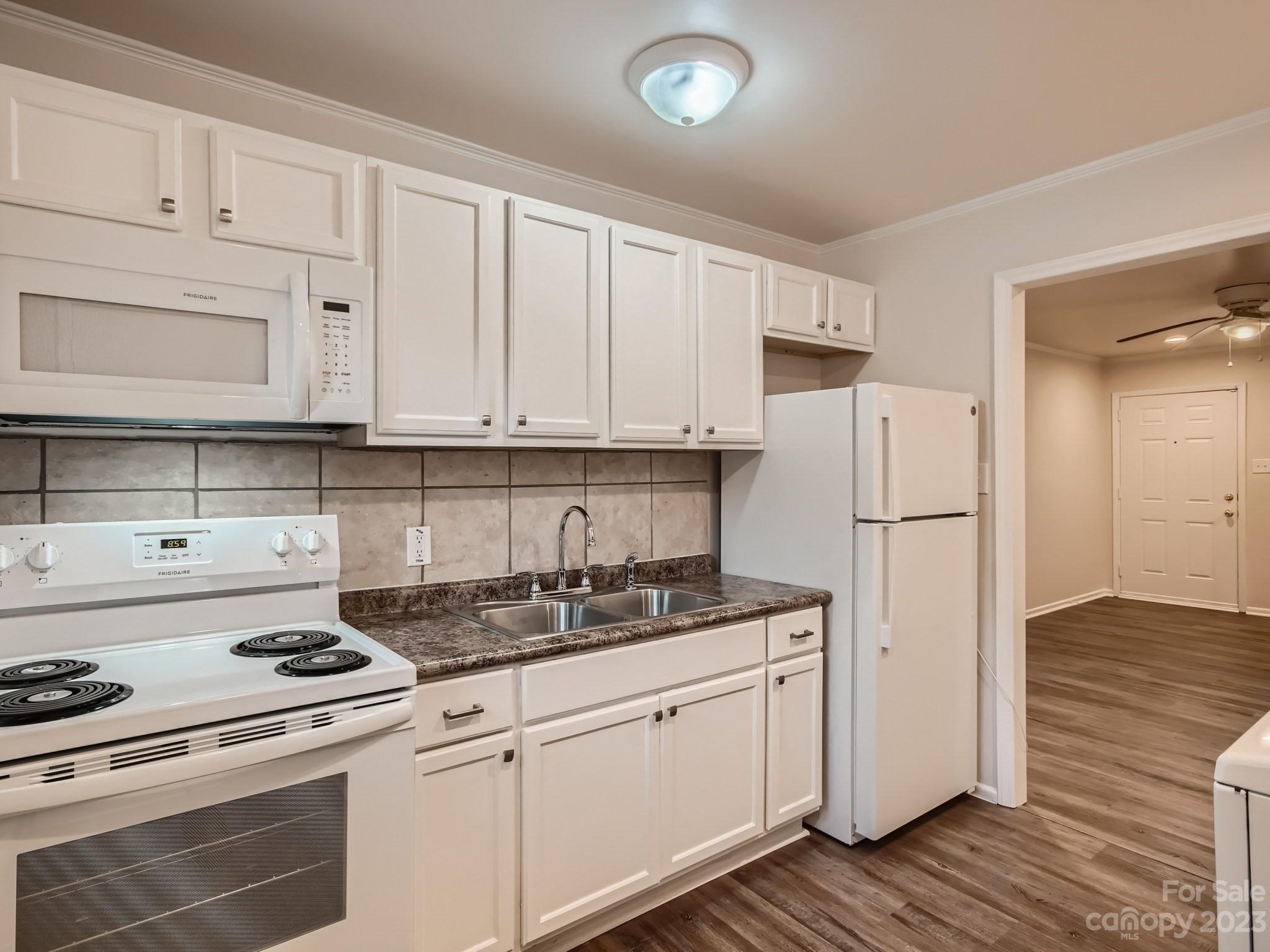 3219 Minnesota Road Charlotte, NC 28208 - Photo 5 of 11 a kitchen with appliances a sink and cabinets