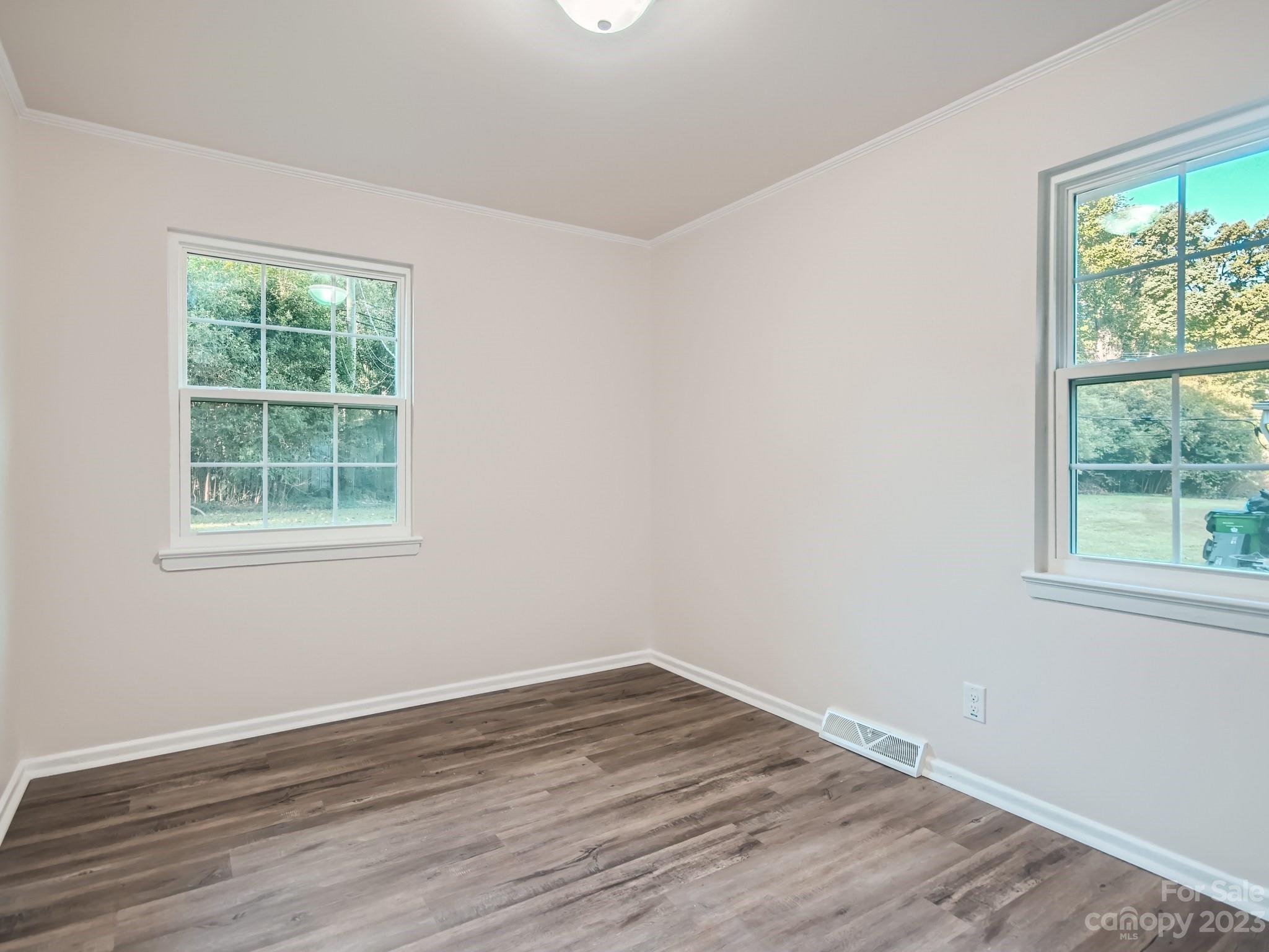 3219 Minnesota Road Charlotte, NC 28208 - Photo 9 of 11 a view of a room with wooden floor and windows in it
