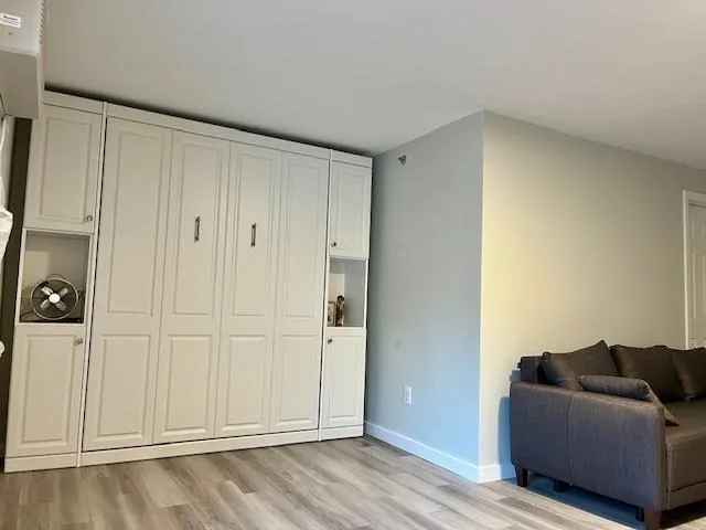 a living room with furniture and a ceiling fan