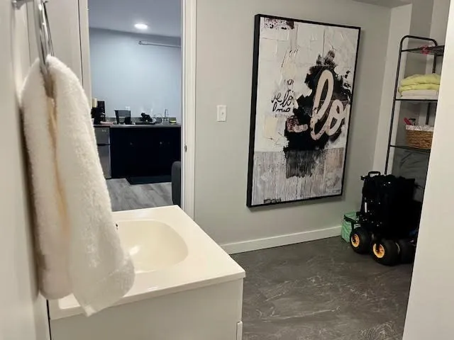 a view of a hallway with stairs and a closet