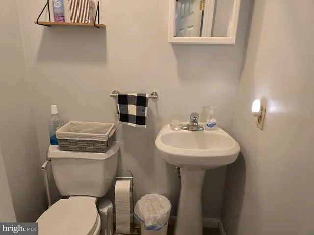 a bathroom with a toilet sink and mirror
