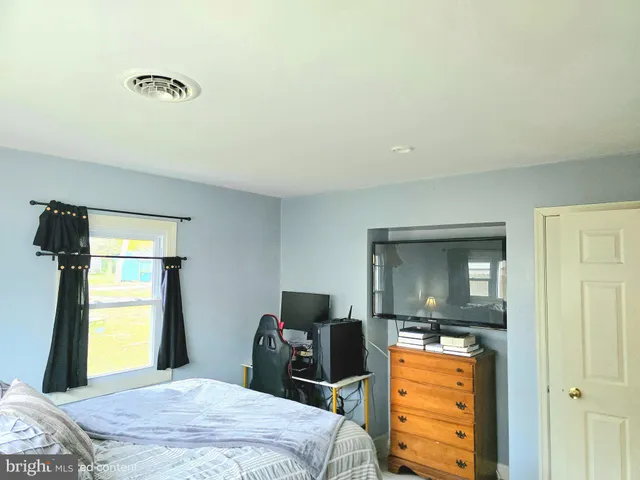 a bedroom with a bed and a television