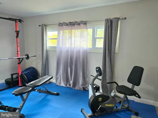 a room with gym equipment and a large window