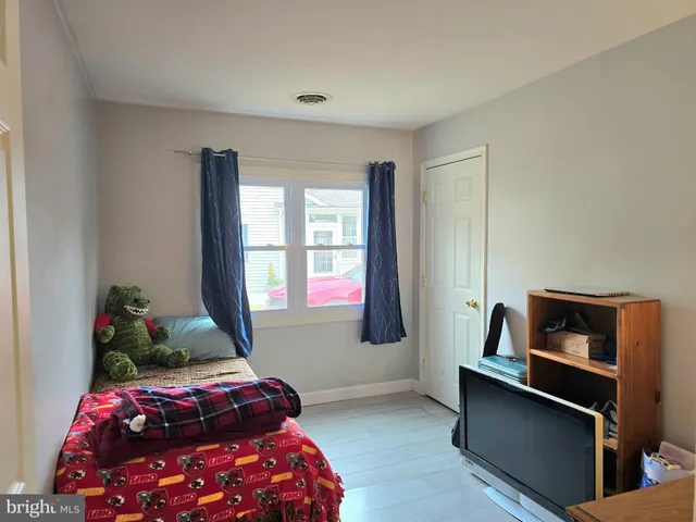 a bedroom with a bed and windows