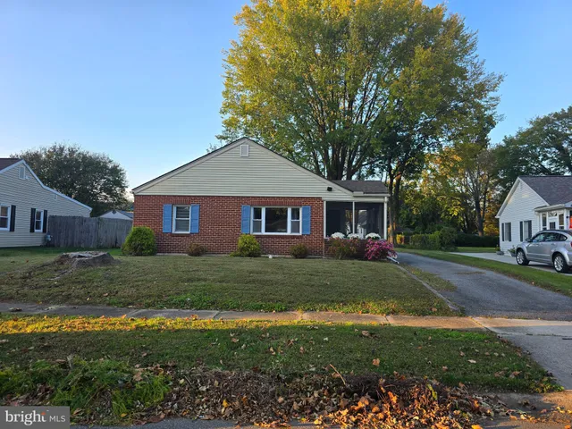 a front view of house with yard and trees around