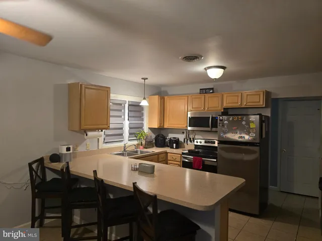 a kitchen with refrigerator cabinets dining table and chairs