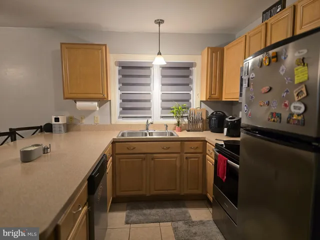 a kitchen with stainless steel appliances a sink stove and cabinets