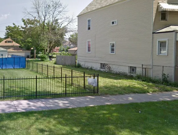 a view of a backyard with a fence