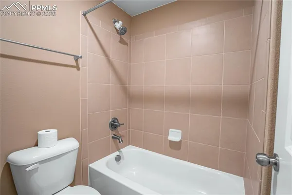 a bathroom with a toilet and shower