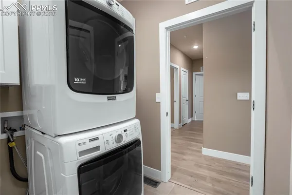 a view of a hallway with washer and dryer