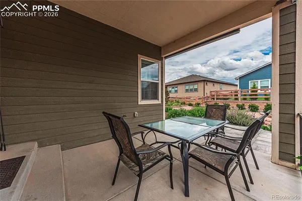 a view of a patio with a table and chairs