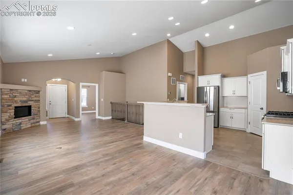 a view of kitchen with stainless steel appliances a refrigerator and a stove top oven