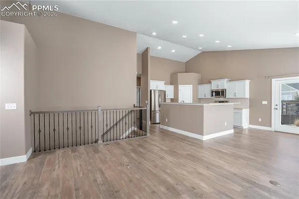 a view of a kitchen with wooden floor