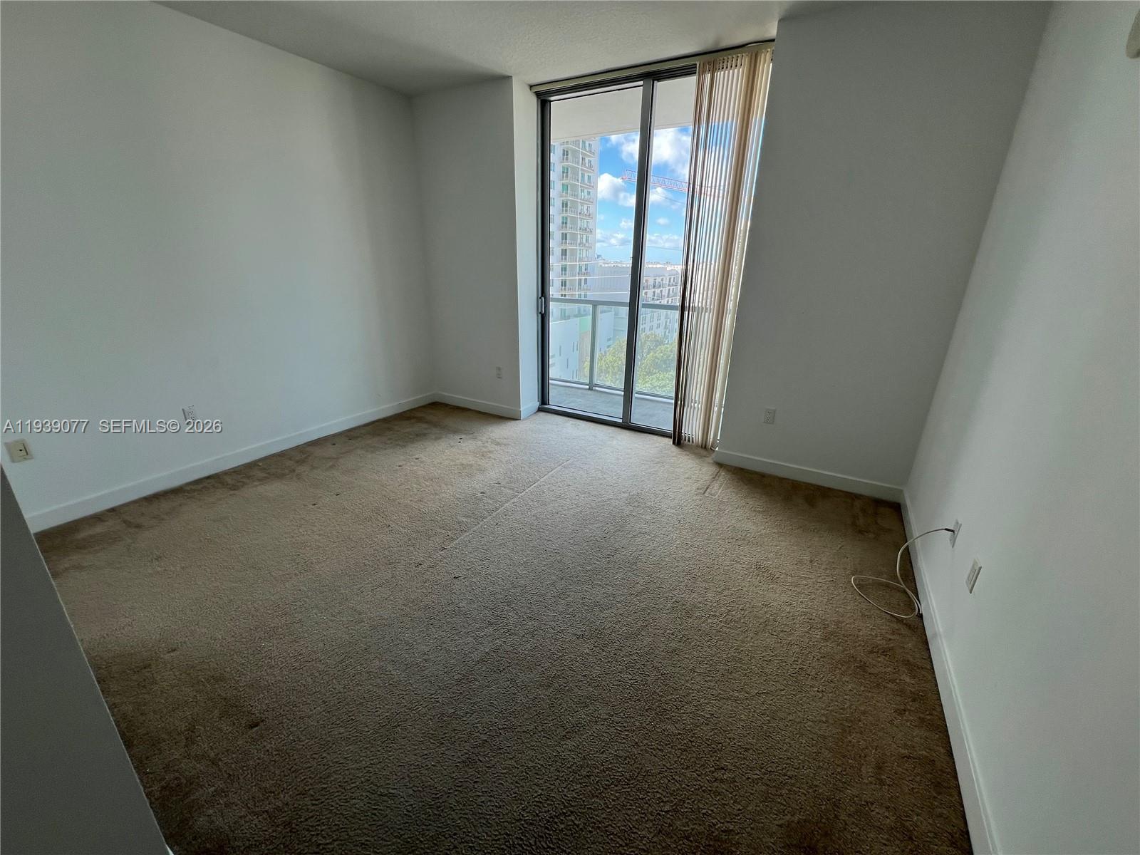 79 Southwest 12th Street, Unit 1112S Miami, FL 33130 - Photo 7 of 9 an empty room with windows