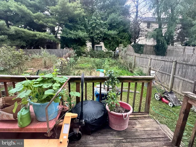 a front view of a house with garden and sitting area